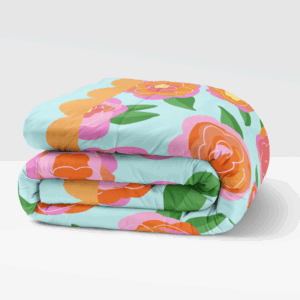 blue folded comforter with pink and orange flowers